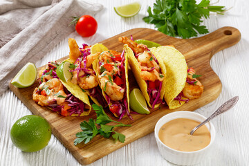 Bang Bang Shrimp Tacos on wood board, top view