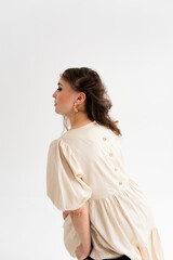 Beautiful young woman with long hair in a photo studio. 
