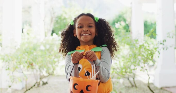 Video portrait of happy african american girl trick or treating for halloween