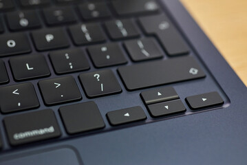 Modern, slim, backlit laptop membrane keyboard. Black keyboard large board. Selective focus....