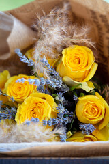 Bouquet of yellow roses and lavender. Floral shop concept