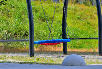 Swing on the children's playground on a summer day