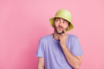 Photo of young guy good mood interested look empty space arm finger touch face cunning plan isolated on pink color background