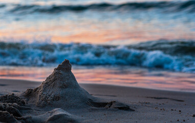 Mound of sand on the beach at sunset