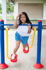Young girl doing exercise with colorful equipment exercise.