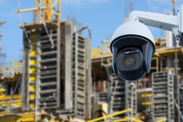 security CCTV camera or surveillance system with construction site on blurry background.