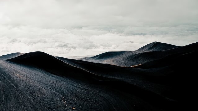 Minimal dark wallpaper. Black mountain with grey clouds, sand dunes, sombre, moody 4k background.