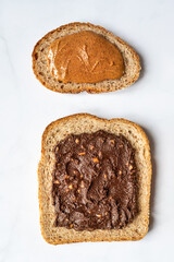 Open sandwiches from various kind of wholegrain bread with different nut butter, such as peanut, crunchy cashew and almond butter