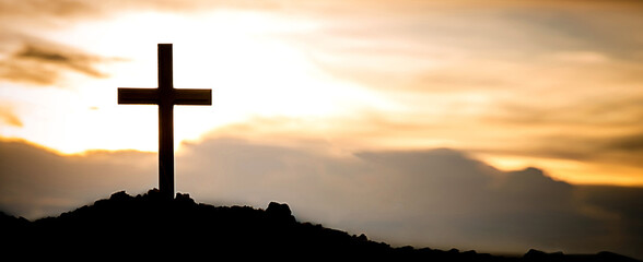 Fototapeta na wymiar The silhouette cross standing on meadow sunset and flare background. Cross on a hill as the morning sun comes up for the day. The cross symbol for Jesus christ. Christianity, religious, faith, Jesus .