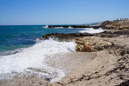 Waves splash against rocks on Anissaras beach.