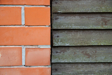 Background template wall fence made of orange bricks and gray boards