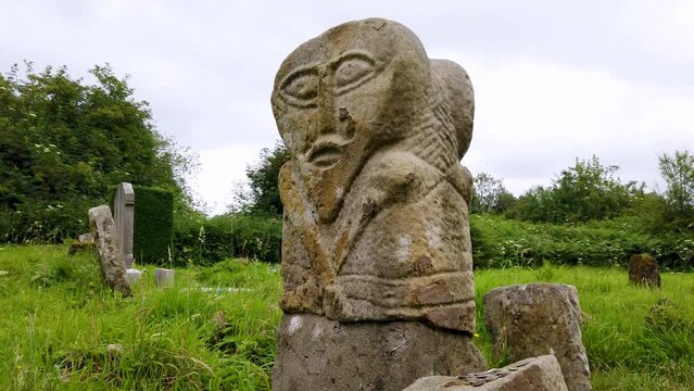 This is a bronze age stone carviing with two faces,called Janus, located In Caldragh Cemetery on Boa Island, Lower Lough Erne. Northern Ireland