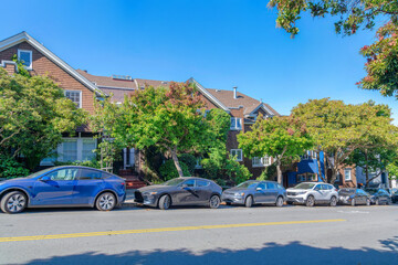 Parked vehicles on the side of the road at the front of the houses at San Francisco, California