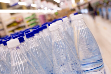 water bottles with blue caps in supermarket