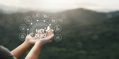 Net Zero icon in hand, carbon neutral and net zero concept. Carbon for a net zero greenhouse gas emissions target weather neutral long term strategy on green background