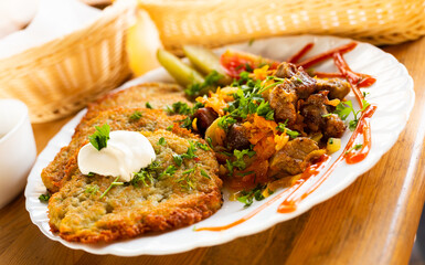 potato pancakes with grilled beef dish on a white plate
