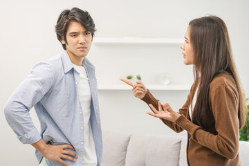 Asian young couple fight standing on white background, relationship in trouble. Different angry, use emotion shouting at each other. Argue husband has expression of disappointment and upset with wife.