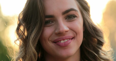 Hispanic latina girl smiling and laughing to camera. Portrait of young woman looking to directly to camera happy with authentic laugh