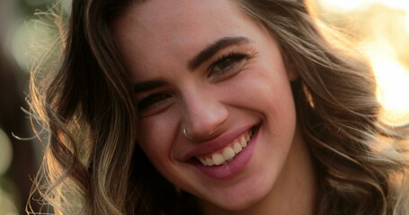 Hispanic latina girl smiling and laughing to camera. Portrait of young woman looking to directly to camera happy with authentic laugh