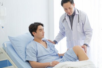 Fototapeta premium Orthopedic professional doctor interact with patient who lie on bed , Knee pain patient get treatment advice doctor in examination room.