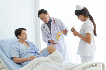 Fototapeta premium Orthopedic professional doctor and nurse interact with patient who lie on bed , Knee pain patient get treatment advice doctor in examination room.