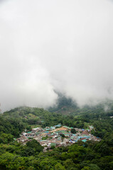 view of the doi pui local countryside village among the mountain hill range surround with mist fog above cloud sky