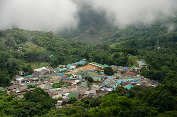 Fototapeta na wymiar view of the doi pui local countryside village among the mountain hill range surround with mist fog above cloud sky