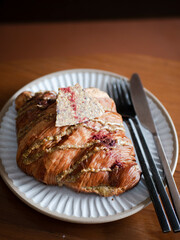 a plate of pistachio croissant in minimal japanese style cafe