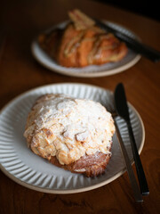 a plate of almond croissant with pistachio croissant in minimal japanese style cafe