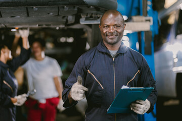 portrait Black African mechanic garage worker check auto service team staff smart standing happy...