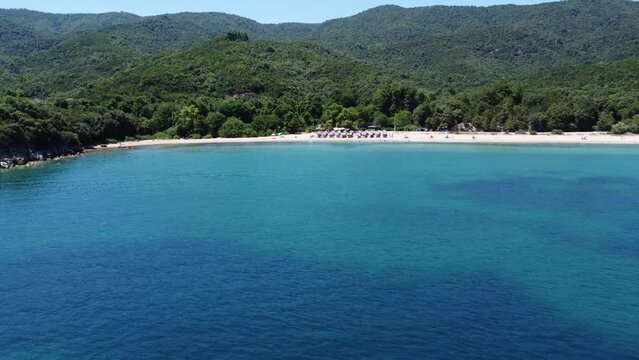 Aerial view of the Babylon beach with people swimming in  turquoise water on a sunny day