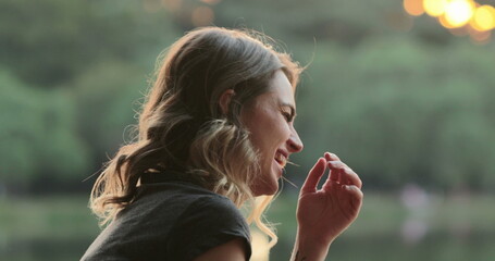 Girl speaking to friend in conversation, burts laughing out loud to friend joke. Real life authentic smile and spontaneous laugh