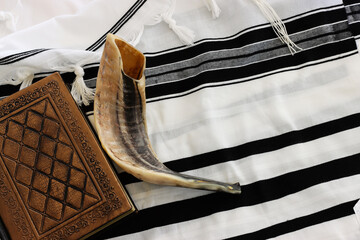 Fototapeta premium religion image of shofar (horn) on white prayer talit. Rosh hashanah (jewish New Year holiday), Shabbat and Yom kippur concept