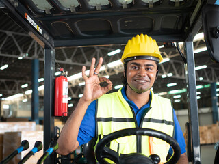 Male man foreman employment yellow hardhat helmet safety happy smile cheerful ok okay black dark african india person sitting drive forklift cargo logistic import export factory warehouse construction - obrazy, fototapety, plakaty