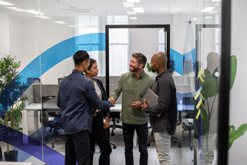 Businesspeople shaking hands in a corporate office