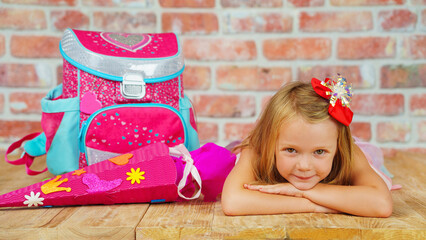 A happy little girl ready for school, first grade smiles at the camera. back to school.