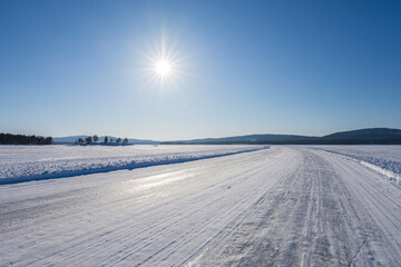 Fototapeta na wymiar Ice road over Lake Pielinen in Eastern Finland. The longest official ice road in Europe’s inland waterways.