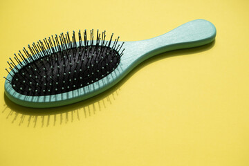 Green comb on the yellow background, empty space for text