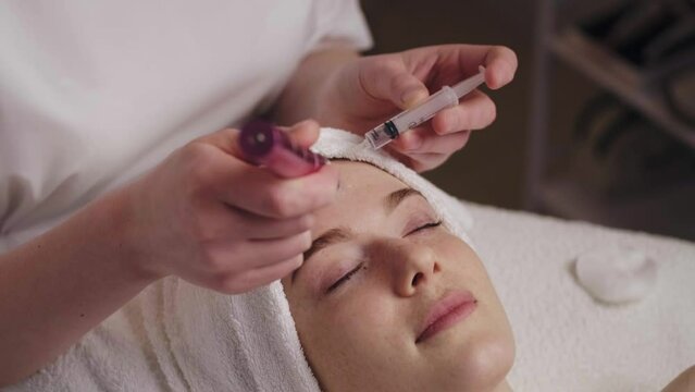 Cosmetologist makes the microdermabrasion procedure of the face skin in a beauty salon. Woman beauty face. Beauty skin. Skin care.