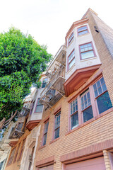 Low angle view of a four-storey residential house building in San Francisco, CA