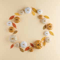 Naklejka na ściany i meble Pumpkins wreath with leaves - beige and white minimalist glossy decorations for autumn and Halloween. Flat lay Wreath with copy space. 3d rendering.