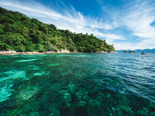 Scenic view of Koh Mai Phai Island crystal clear turquoise sea water with coral reef transparent. Snorkeling spot. Near Koh Lipe Island, Tarutao National Marine Park, Satun, Thailand.