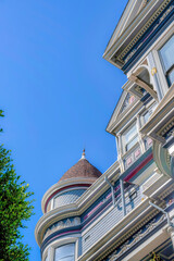 Low angle view of a victorian home with turret wall against the clear sky at San Francisco, CA