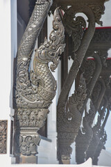 Black naga Carved, on rooftop at Wat Pa Ban Tat temple in Udon Thani Thailand.