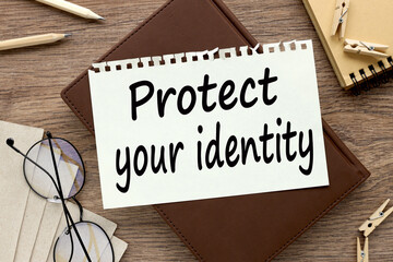 Protect Your Identity. text on paper on a brown notepad. wooden table
