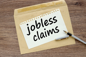 Jobless claims. text on paper on a beautiful envelope. wooden table
