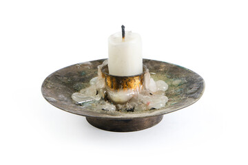 A candle stub in a small, dirty old candelabra.