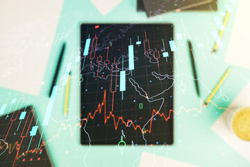 Double exposure of abstract creative financial chart with world map and digital tablet on...