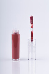 lip gloss applicator with drops of red gloss