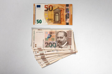 Euro and Croatian kuna banknotes on white background